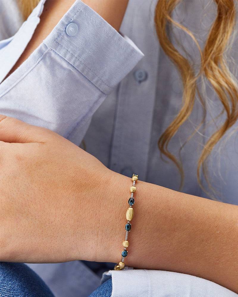 Nanis Bracciale tennis "DANCING AZURE" in oro, diamanti e topazio London blu – Nanis Italian Jewels Sostegno trimestrale